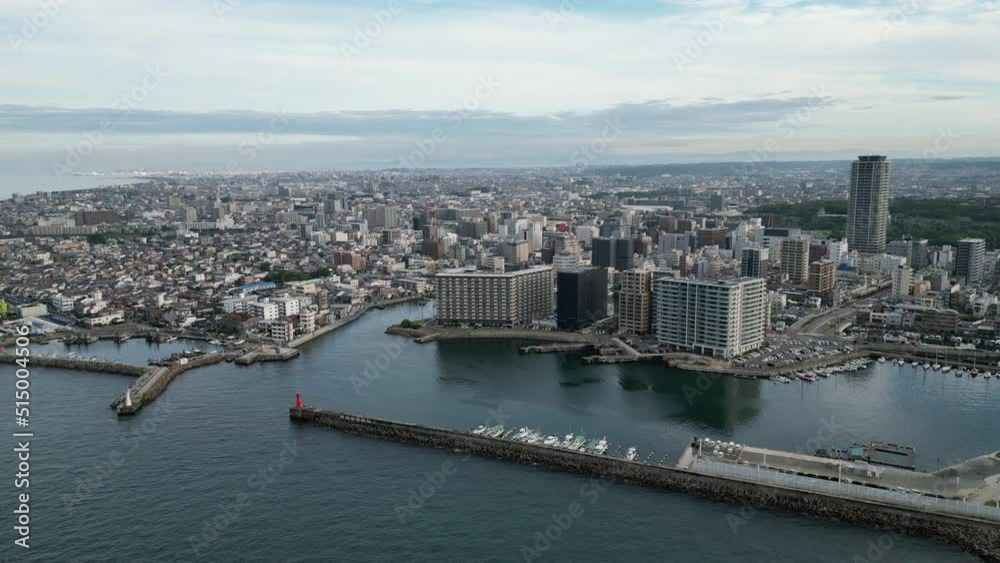 Slow pullback and rise over water with Akashi City harbor in background Slow pullback and rise over water with Akashi City harbor in background