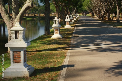 White cement lamps decorate the walkway in the Sukhothai Historical Park.
