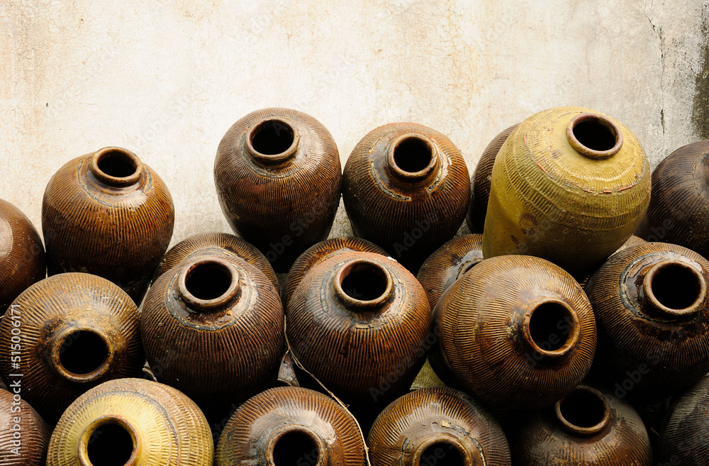 Traditional ceramic jars used to make Xuchang famous soy sauce stacked up against a wall in Tongxiang's Wuzhen Scenic Area in Zhejiang province China. Traditional ceramic jars used to make Xuchang famous soy sauce stacked up against a wall in Tongxiang's Wuzhen Scenic Area in Zhejiang province China.