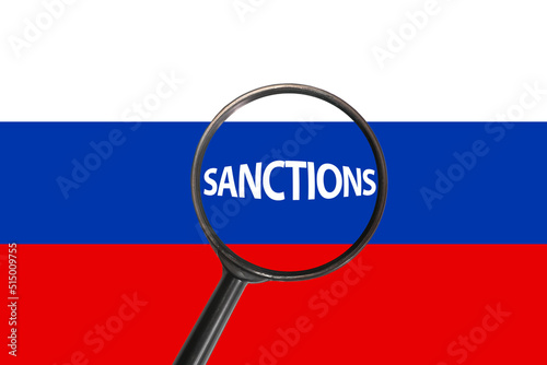 Sanctions against aggressor Russia with magnifier glass, economic and political sanctions against Russia, sanctions on Russian flag