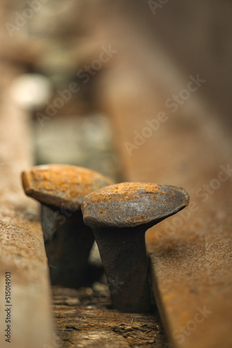 Bolts on a train track used by commuter and freight trains in a suburban town. 
