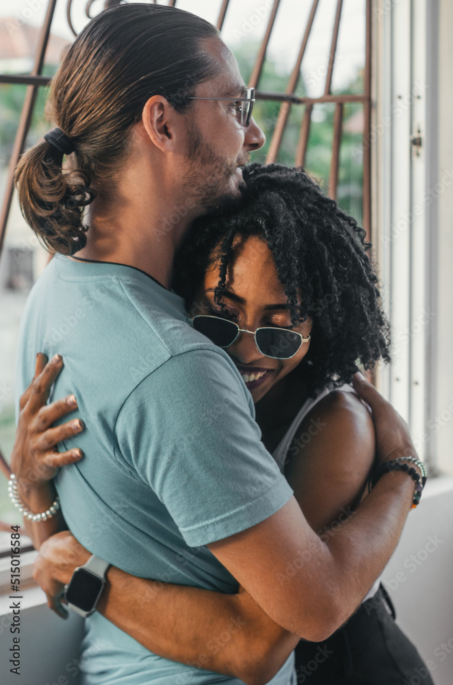 multiethnic couple hugging each other