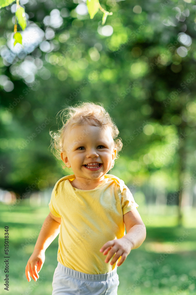Blurred curly girl in motion running on a blurred green background Blurred curly girl in motion running on a blurred green background