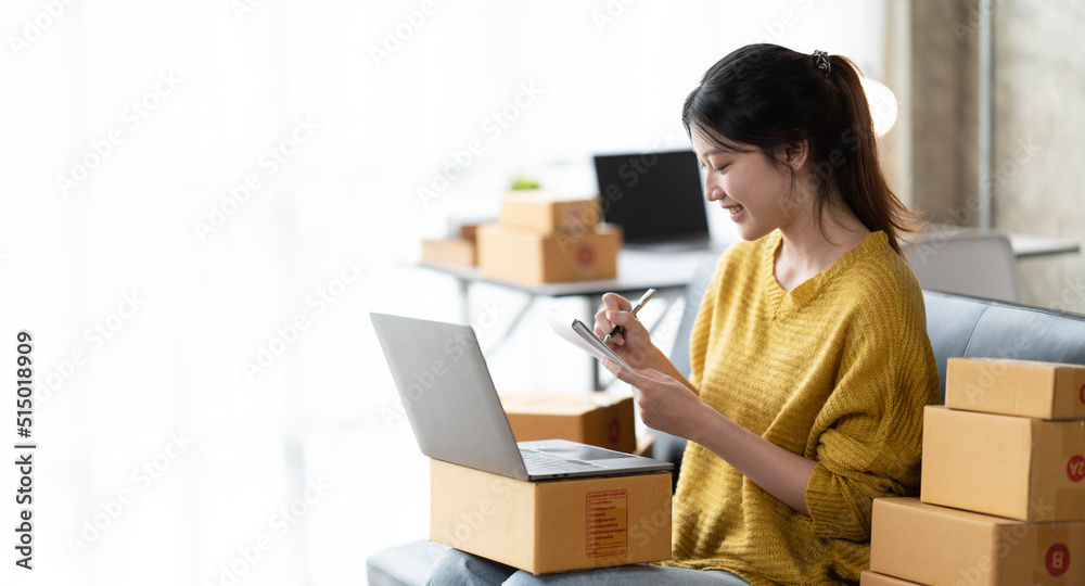 Starting small businesses SME owners female entrepreneurs check online orders to prepare to pack the boxes, sell to customers, sme business ideas online. Starting small businesses SME owners female entrepreneurs check online orders to prepare to pack the boxes, sell to customers, sme business ideas online.