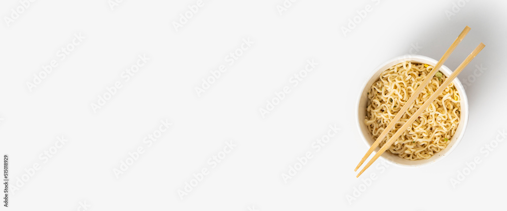 Chinese noodles in a paper mask with wooden chopsticks on a white background.Top view, flay lay. Banner Chinese noodles in a paper mask with wooden chopsticks on a white background.Top view, flay lay. Banner