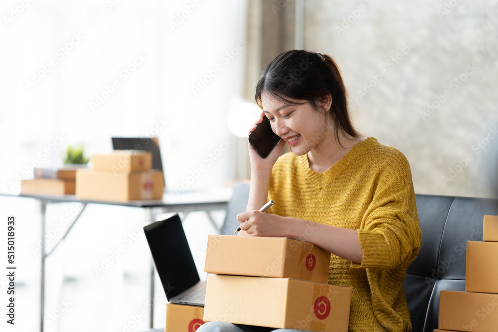 Starting small businesses SME owners female entrepreneurs check online orders to prepare to pack the boxes, sell to customers, sme business ideas online. Starting small businesses SME owners female entrepreneurs check online orders to prepare to pack the boxes, sell to customers, sme business ideas online.