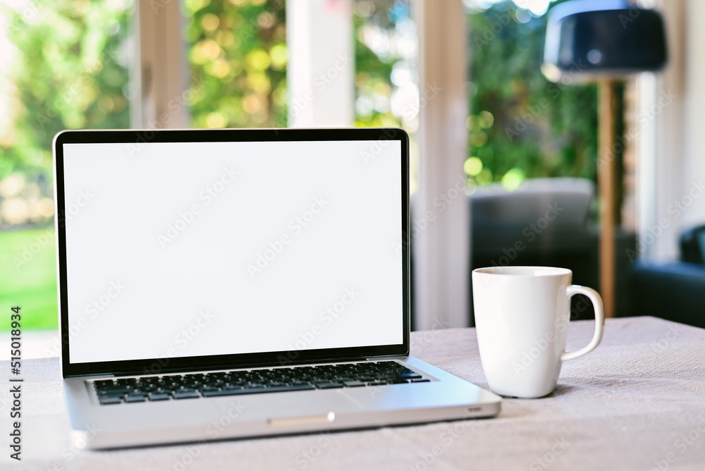 Front view of white screen laptop in the living room near to the garden. Remote work. freelance.Work from home. Telework Front view of white screen laptop in the living room near to the garden. Remote work. freelance.Work from home. Telework