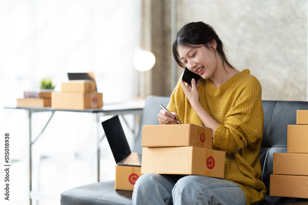 Starting small businesses SME owners female entrepreneurs check online orders to prepare to pack the boxes, sell to customers, sme business ideas online. Starting small businesses SME owners female entrepreneurs check online orders to prepare to pack the boxes, sell to customers, sme business ideas online.