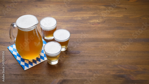 Banner Oktoberfest beer in a jug and glasses, copy space, lager beer, Bavarian beer.