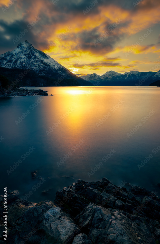 Sunrise with mountains, lake and snow