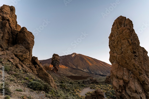 Rogues de Garcia hiking trail with Teide volcano in the background. The famous rock formation is called God`s finger. The picture was taken at sunrise.