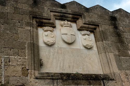 Medieval marble coats of arms on the stone wall of the fortress of Rhodes, Greece