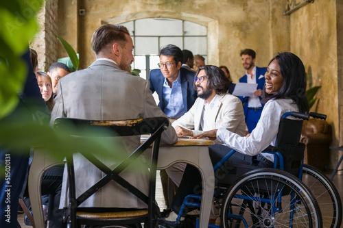 multiracial team work having a large meeting for planning business,african woman on wheelchair discussing with colleagues