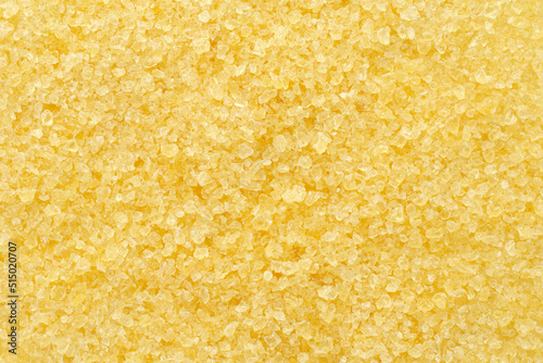 Gelatin, yellow powder top view. Background, texture of crystals of gelatin, close-up. Dry gelatin texture, top view. Dry yellow gelatin powder, top view. Pile of isinglass, top view. photo
