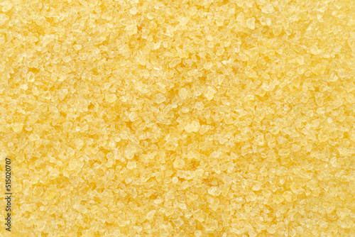 Gelatin, yellow powder top view. Background, texture of crystals of gelatin, close-up. Dry gelatin texture, top view. Dry yellow gelatin powder, top view. Pile of isinglass, top view.