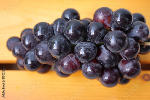 Wallpaper Mural Clusters of ripe purple grapes in wooden background.  Torontodigital.ca