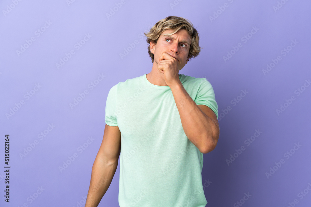 English man over isolated purple background having doubts and with confuse face expression English man over isolated purple background having doubts and with confuse face expression