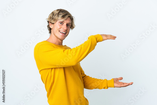 English man over isolated white background holding copyspace to insert an ad