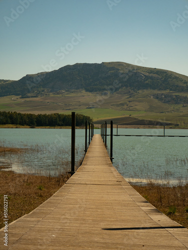 Wooden pier on a lake  trees