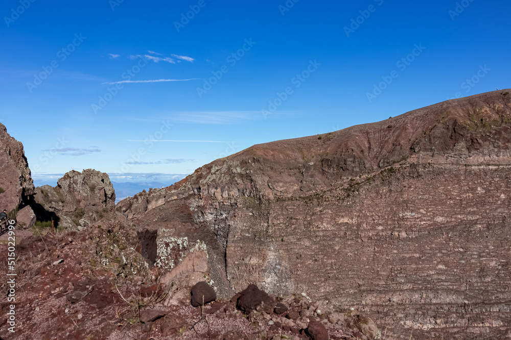 Panoramic view on the edge of the active volcano crater of Mount Vesuvius, Province of Naples, Campania region, Southern Italy, Europe, EU. Volcanic landscape full of stones, ashes and solidified lava