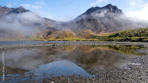 Cloud shrouded mountain reflected in an inland lagoon at Jason Harbor on South Georgia Island