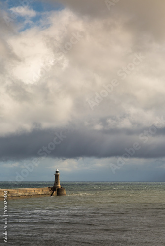 Tynemouth Pier and the Lighthouse guarding the mouth of the River Tyne on a cloudy day © Paul Jackson