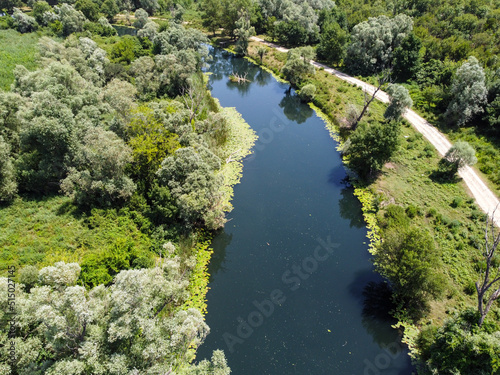 Aerial drone view of lake surrounded by reeds. Beautiful landscape. Colorful swampy marsh in spring. Hutovo blato, nature reserve and bird reserve located in Bosnia and Herzegovina. 