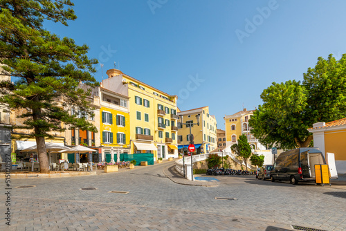 The colorful old town of cafes and shops at the hillside city of Mahon or Mao, Spain, on the Balearic Mediterranean island of Menorca.