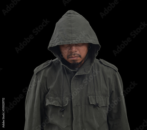 Scary and creepy asian man wearing hood. Isolated on black background.