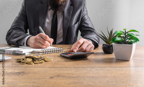 Business man using calculator