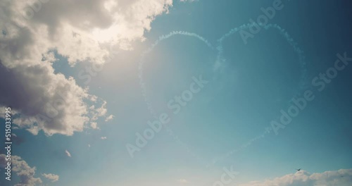A love heart drawn in the blue sky by an airplane photo