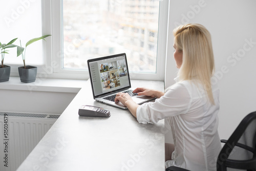 Woman Working From Home Having Group Videoconference On Laptop