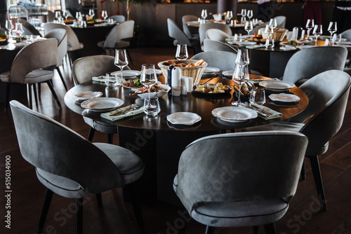 Beautifully organized event - round served table banquet ready for guests. Elegant dinner table
