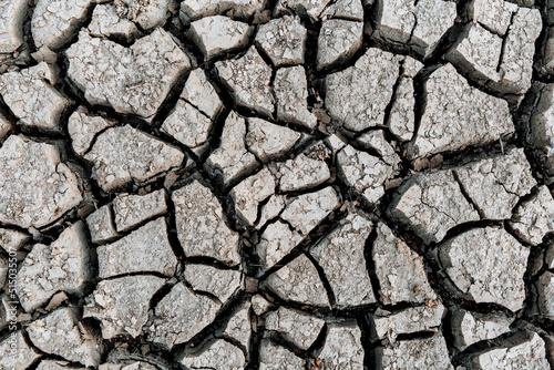 Cracked earth, cracked soil. texture of grungy dry cracking parched earth.