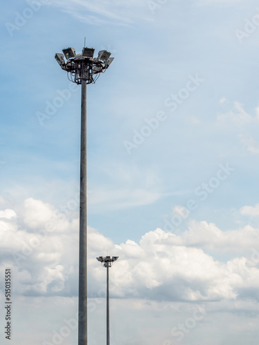 Two sport light stands out on a blue sky background.Lighting for road poles, electric industry, stadium or sports lighting.