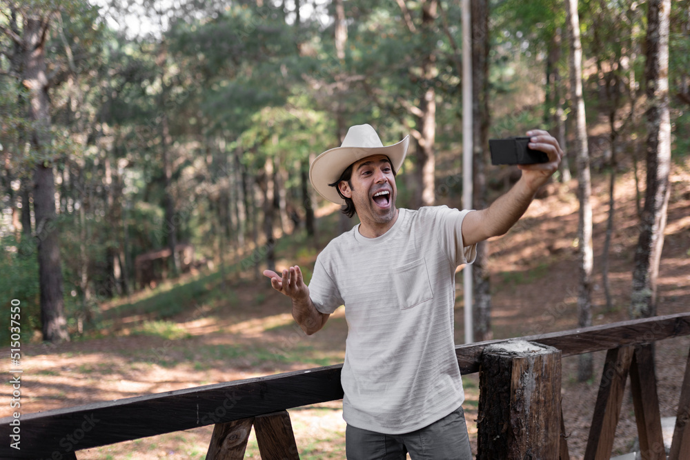 Obraz premium A mexican young man is filming himself talking to the camera for an internet video in the nature