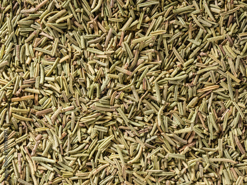 Dried rosemary condiment background, used as a spice in cooking. Organic Dried Rosemary, overhead view. Top view, Flat lay. Organic food, healthy lifestyle. Food flavoring