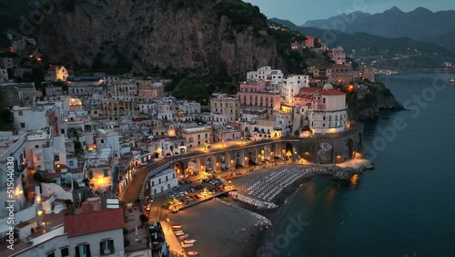 aerial view of Amalfi town at night in Italy, famous Amalfi coast in the evening, touristic mediterranean town on the coast near Naples