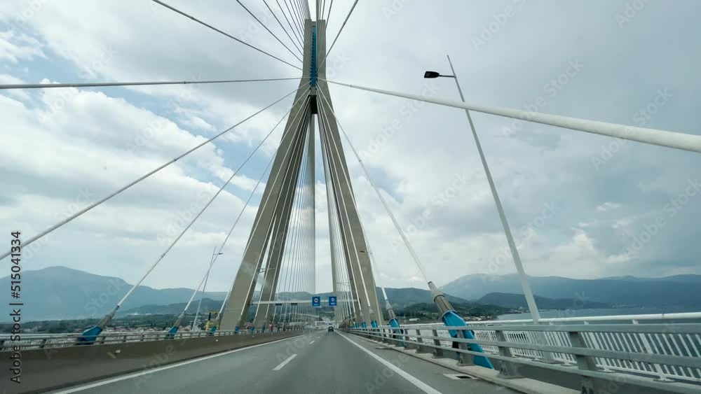 Driving on Rio–Antirrio Bridge in Gulf of Corinth near Patras Grece. Big bridge over Gulf of Corinth. Travel in Greece by car on the road. Road trip. Highway on the structure. Wide angle view Driving on Rio–Antirrio Bridge in Gulf of Corinth near Patras Grece. Big bridge over Gulf of Corinth. Travel in Greece by car on the road. Road trip. Highway on the structure. Wide angle view