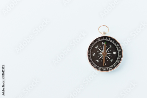 Vintage compass on light blue background. Journey and adventure concept. Flat lay, top view.