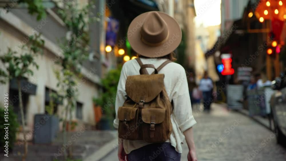 Tourist with a backpack walking along a pretty street in Istanbul