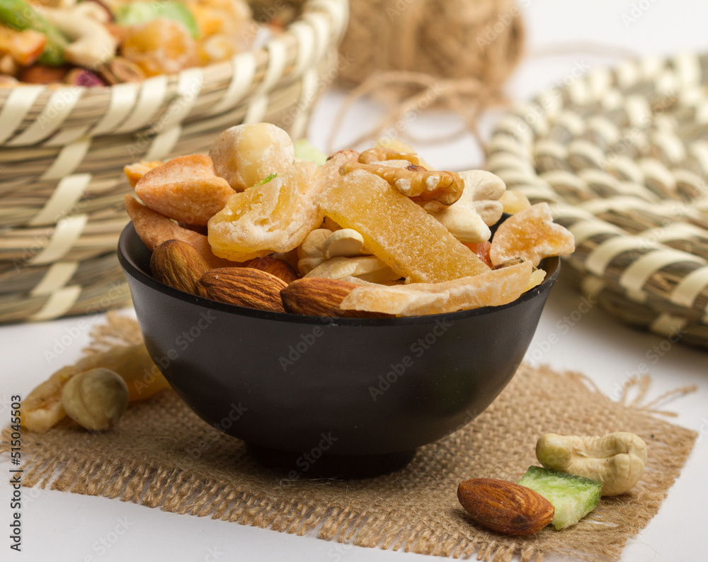 Assorted mix power nuts served in a bowl isolated on napkin side view of nuts on grey background