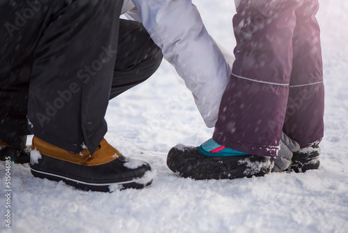 Winter shoes in the snow. Close-up of winter shoes. Children's waterproof shoes for walking in the snow. Low temperature and falling snow