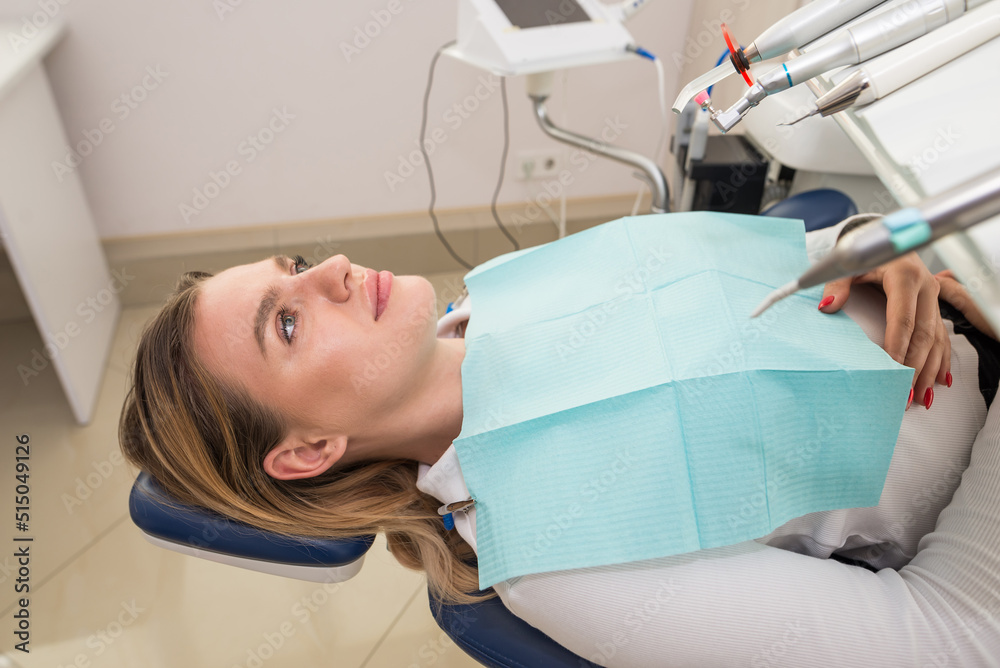 patient lies in a dental chair waiting for tooth treatment patient lies in a dental chair waiting for tooth treatment