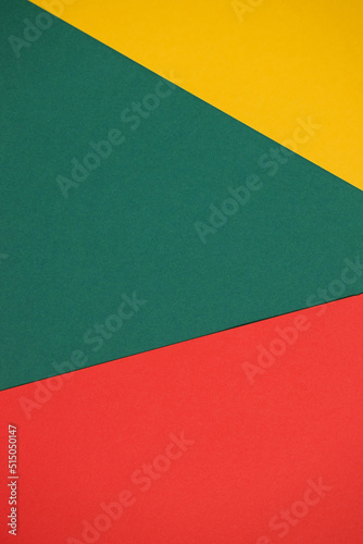 Bright abstract geometric paper background. Yellow, green, red trendy colors. The backdrop for an invitation card, greeting card or web design. Creative copy space, flat lay
