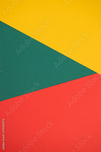 Bright abstract geometric paper background. Yellow, green, red trendy colors. The backdrop for an invitation card, greeting card or web design. Creative copy space, flat lay