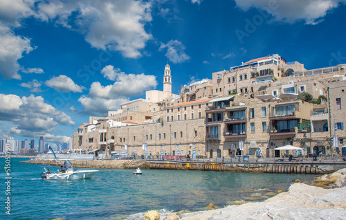 Title: Tel Aviv, Jaffa Israel, July 4th, 2022: Old Jaffa city, old port and coastal line of Tel Aviv . blue sky with clouds