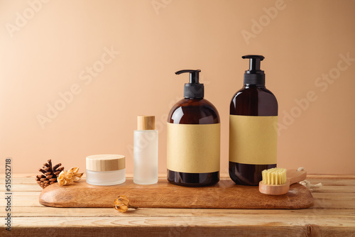 Body care products with labels for mock up packaging design on wooden table over beige background.