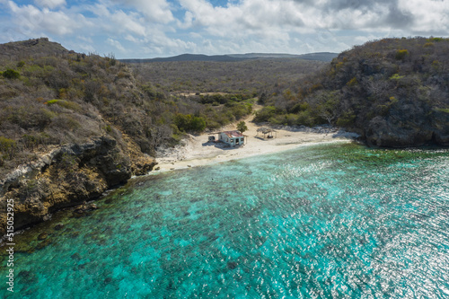 Aerial view of the coast of Curaçao in the Caribbean with beach, cliff, and turquoise ocean photo