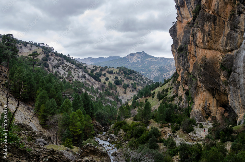 mountain landscape with a river in the center and the steep mountain on the right, on a cloudy autumn day. Borosa River, Sierra de Segura, Spain mountain landscape with a river in the center and the steep mountain on the right, on a cloudy autumn day. Borosa River, Sierra de Segura, Spain